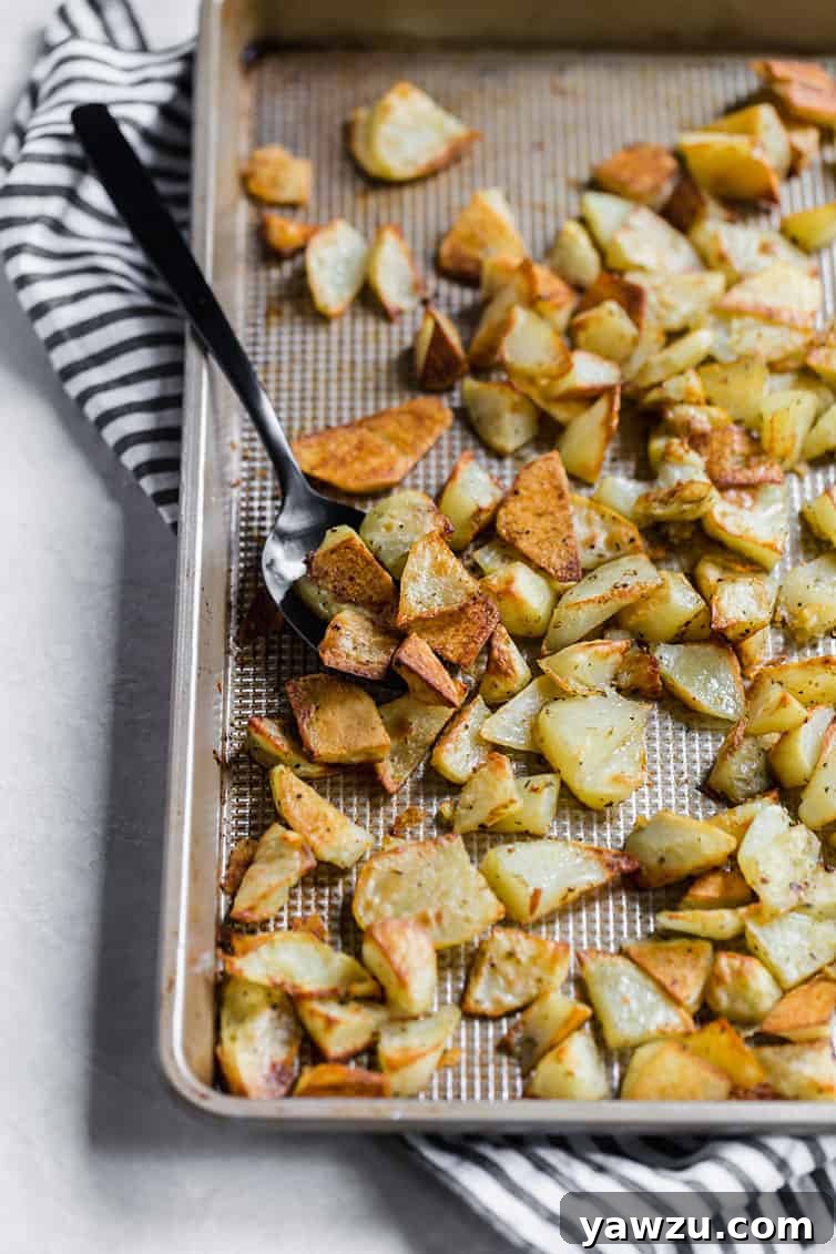 A hot baking pan of perfectly roasted potatoes, golden brown and crispy, straight from the oven and ready to be served.