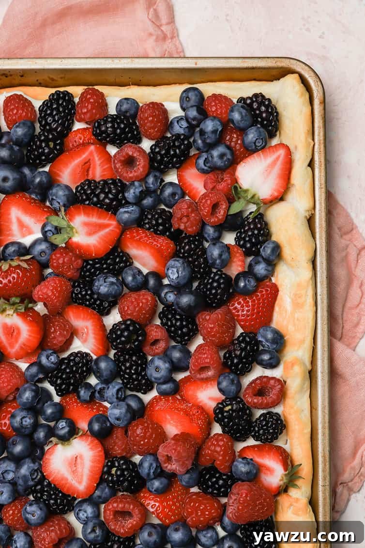 Fruit pizza topped with fresh berries.