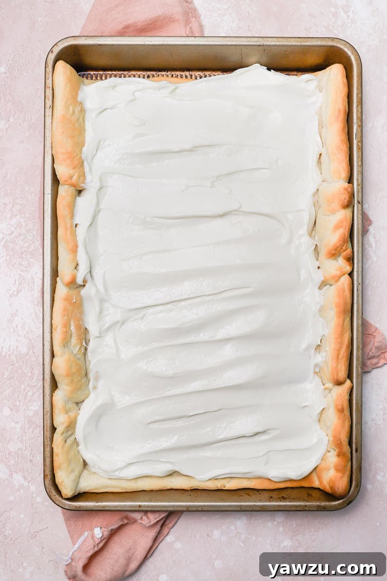 Baked crescent roll crust topped with cream cheese frosting.