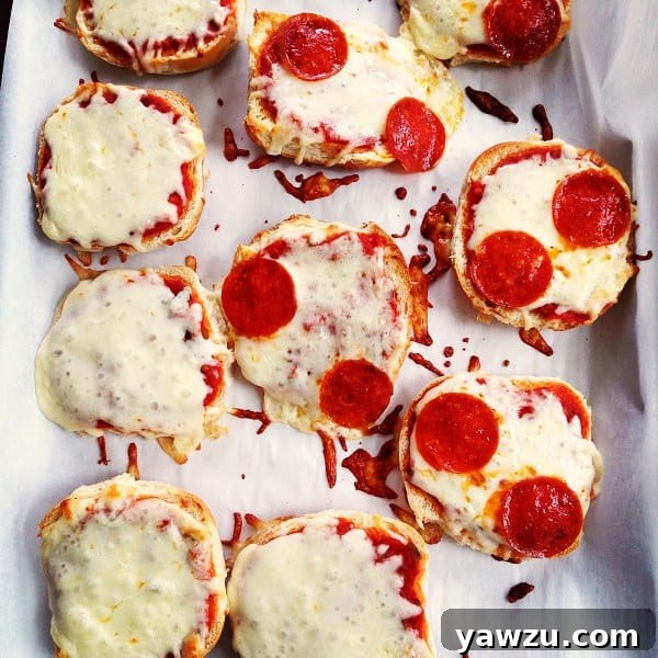 Close-up of freshly baked Pizza Burgers with melted cheese and pepperoni on toasted buns.