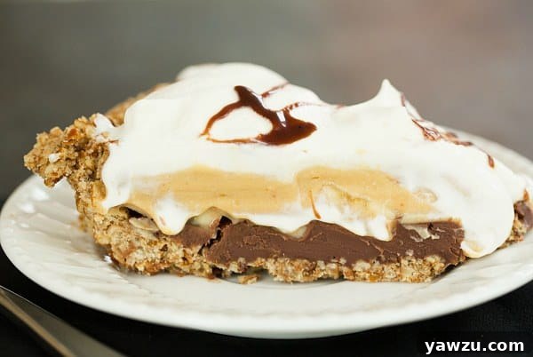 Layers of Chocolate-Peanut Butter Banana Cream Pie with Pretzel Crust, showcasing the ganache and bananas.