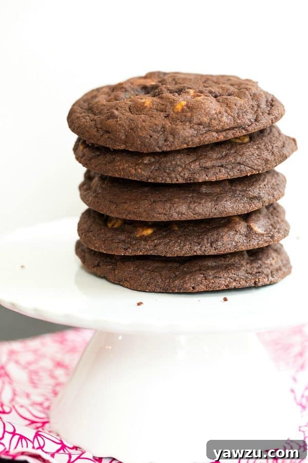 Giant Chocolate Peanut Butter Chip Cookies with a perfect chewy, fudgy texture on a cooling rack