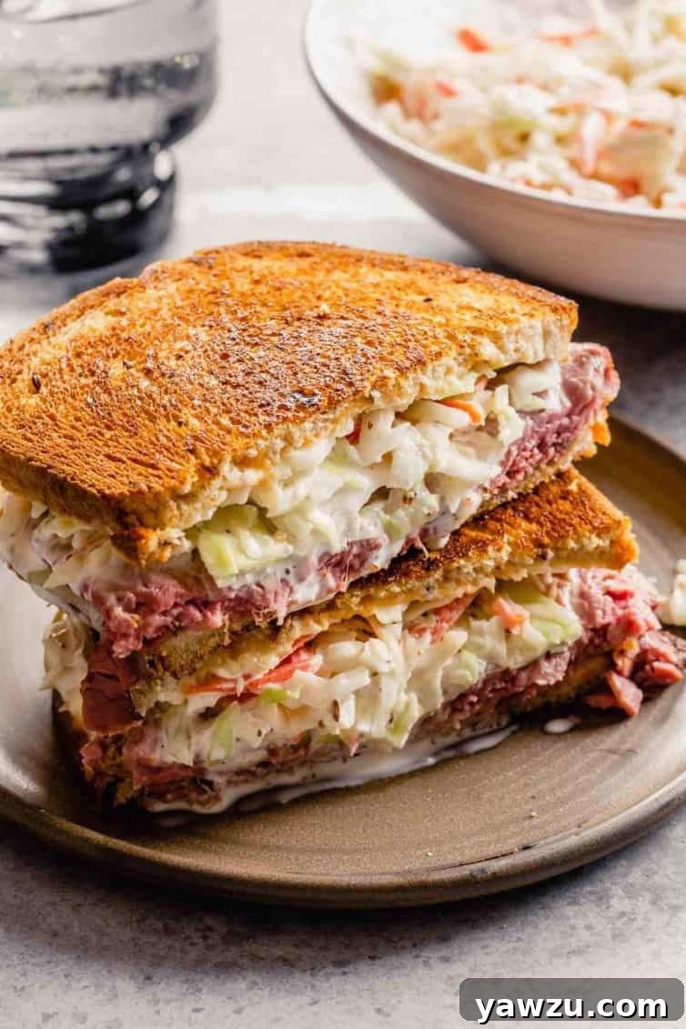 A sandwich with coleslaw inside on a brown plate.