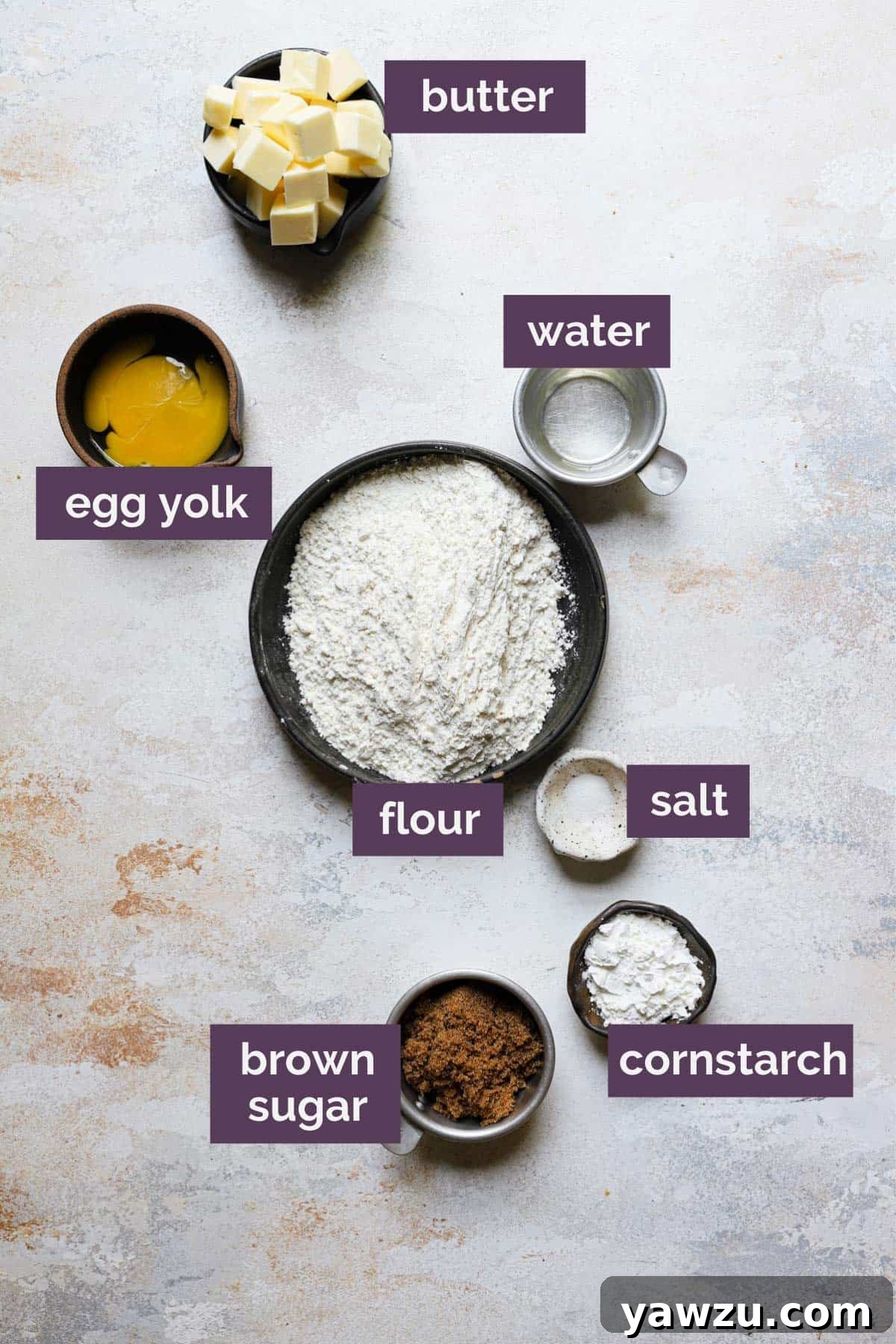The ingredients for the shortbread crust in bowls with purple labels naming each ingredient.
