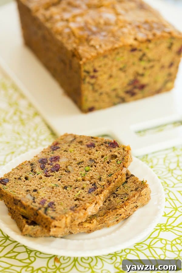 Spiced Zucchini Bread with Dried Cranberries and Walnuts - A perfect fall recipe combining fresh zucchini, warm spices, crunchy walnuts, and tart cranberries for a supremely moist and flavorful loaf.