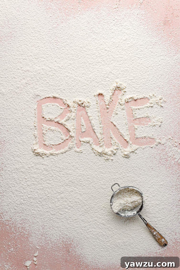 Flour dusted on a counter with the word "bake" traced in it.