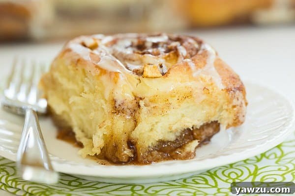 Freshly baked Salted Caramel Apple Cinnamon Rolls cooling in a pan