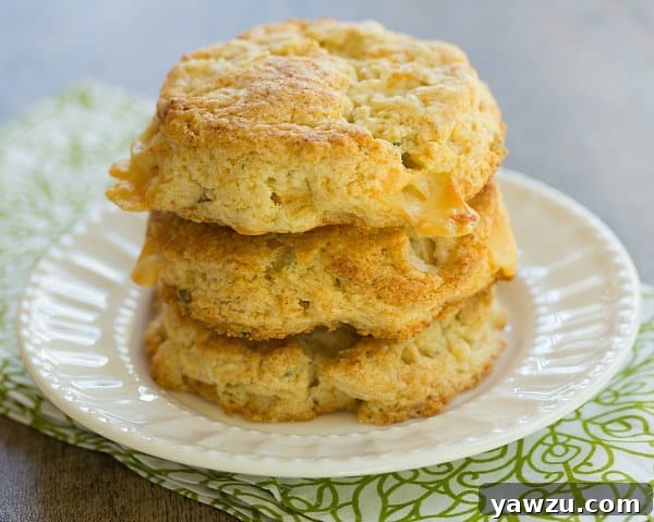 Close-up of baked Apple Gruyere and Sage Scones on a baking sheet