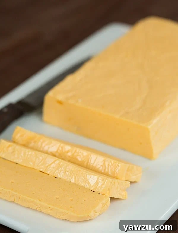 Homemade Velveeta Cheese block on a cutting board, ready to be used in recipes.