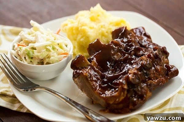 Tender Slow Cooker BBQ Ribs cooking in a crock-pot with onions.