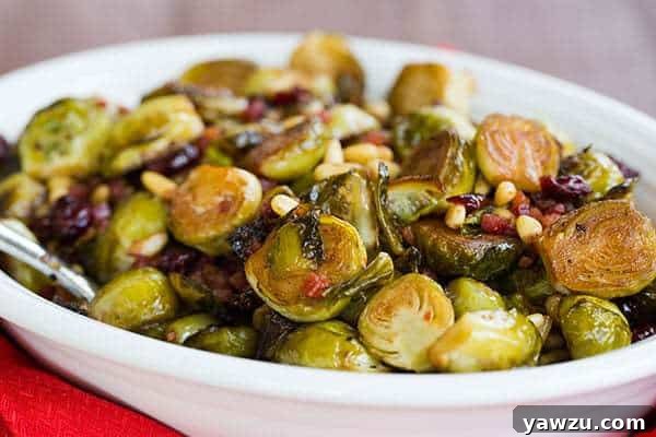 Serving of Brussels Sprouts with Pancetta, Cranberries & Pine Nuts on a plate, ready to be enjoyed as a holiday side.