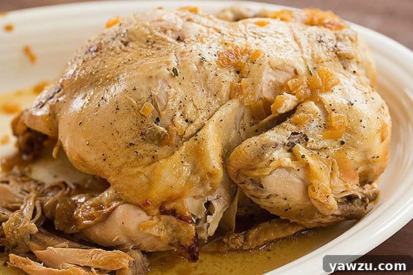A beautifully cooked Slow Cooker Whole Roasted Chicken, falling off the bone and ready for a delicious meal.