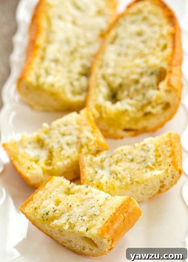 Homemade Cheesy Garlic Bread - Golden brown, crispy crust with melted cheese and fresh parsley