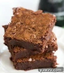 A square of dark, fudgy Guinness Chocolate Brownie, sliced and ready to serve.