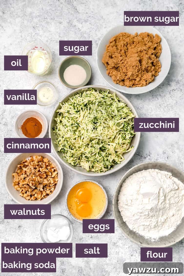 Various ingredients for zucchini bread, including flour, sugar, eggs, and shredded zucchini, prepped and organized in bowls on a kitchen counter, ready for mixing.