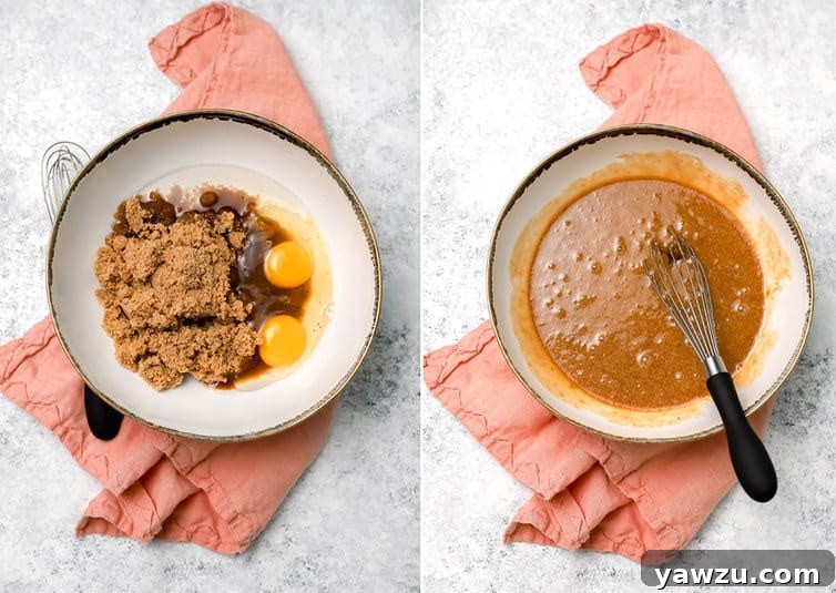 A person whisking together wet ingredients such as brown sugar, oil, eggs, and vanilla extract in a separate bowl for zucchini bread, creating a smooth mixture.