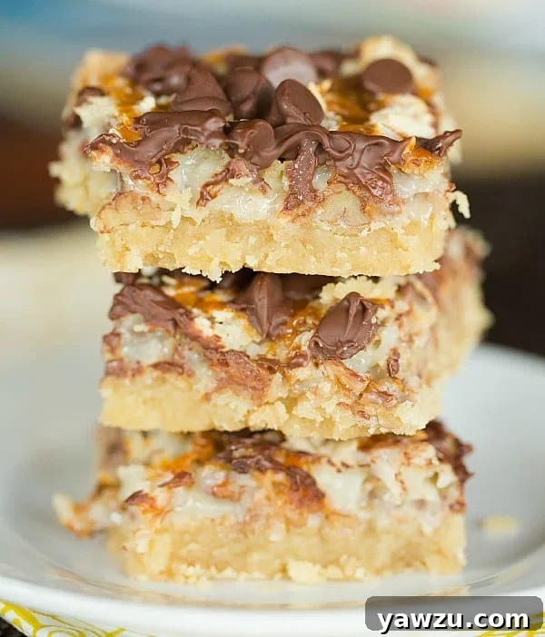 Ultimate Magic Bars - Sweetened condensed milk, brown sugar shortbread, pecans, coconut, chocolate, and caramel create an irresistible dessert bar. Easy to make and a crowd-pleaser!