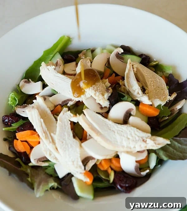 A serving of fresh Honey Balsamic Vinaigrette in a small bowl, garnished with a sprig of rosemary, ready to be enjoyed.