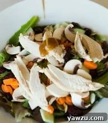 A small bowl of Honey Balsamic Vinaigrette with a spoon, ready for use.