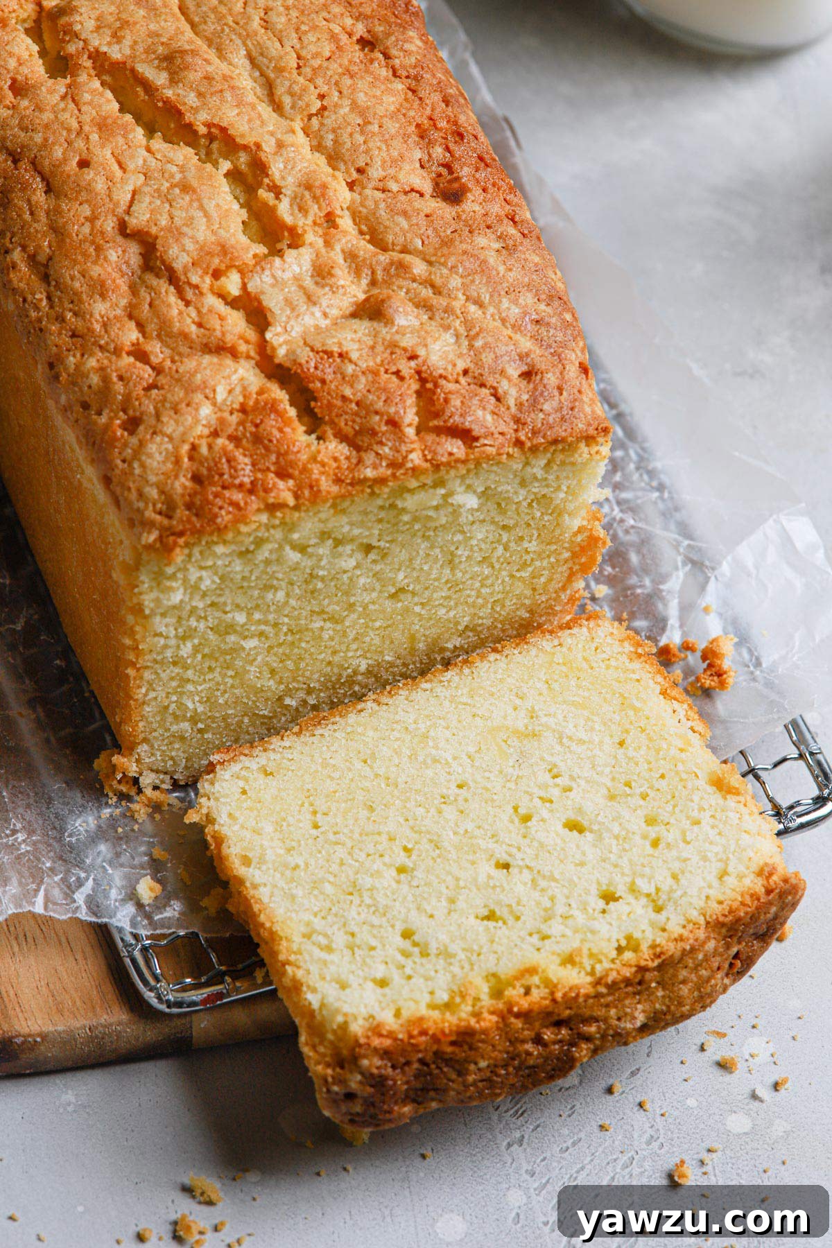 Loaf of buttery pound cake with a piece sliced off.
