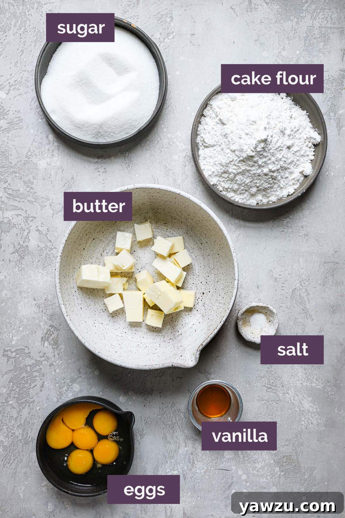 Ingredients for pound cake prepped in bowls and labeled.