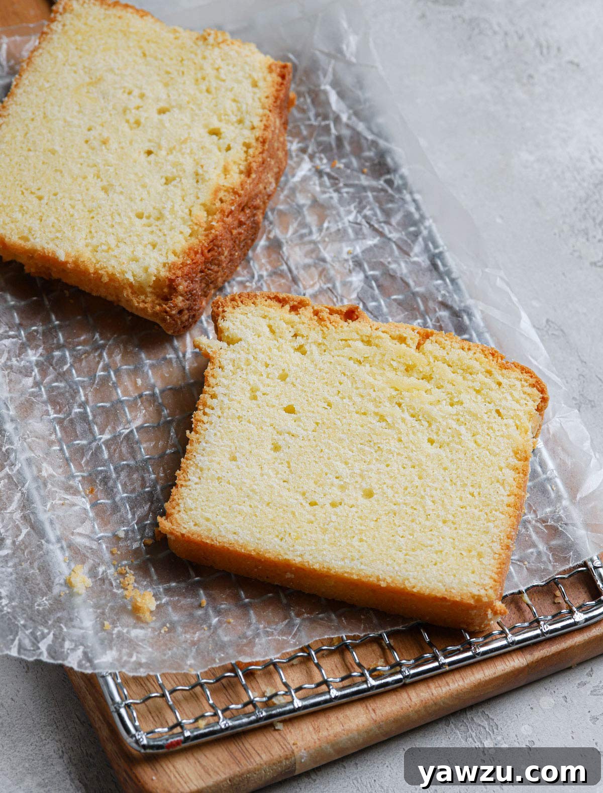 Slices of pound cake on a wax paper-lined cooling rack.
