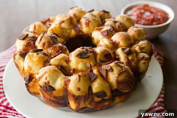 Close-up of Pepperoni Pizza Monkey Bread, showcasing the golden-brown crust and melted cheese inside.