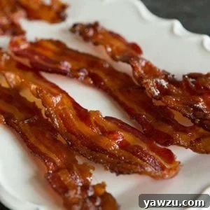 A small bowl of Bourbon-Brown Sugar Bacon, showcasing its crispy texture.