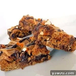 Chocolate chip and pretzel cookie bars on a white plate.