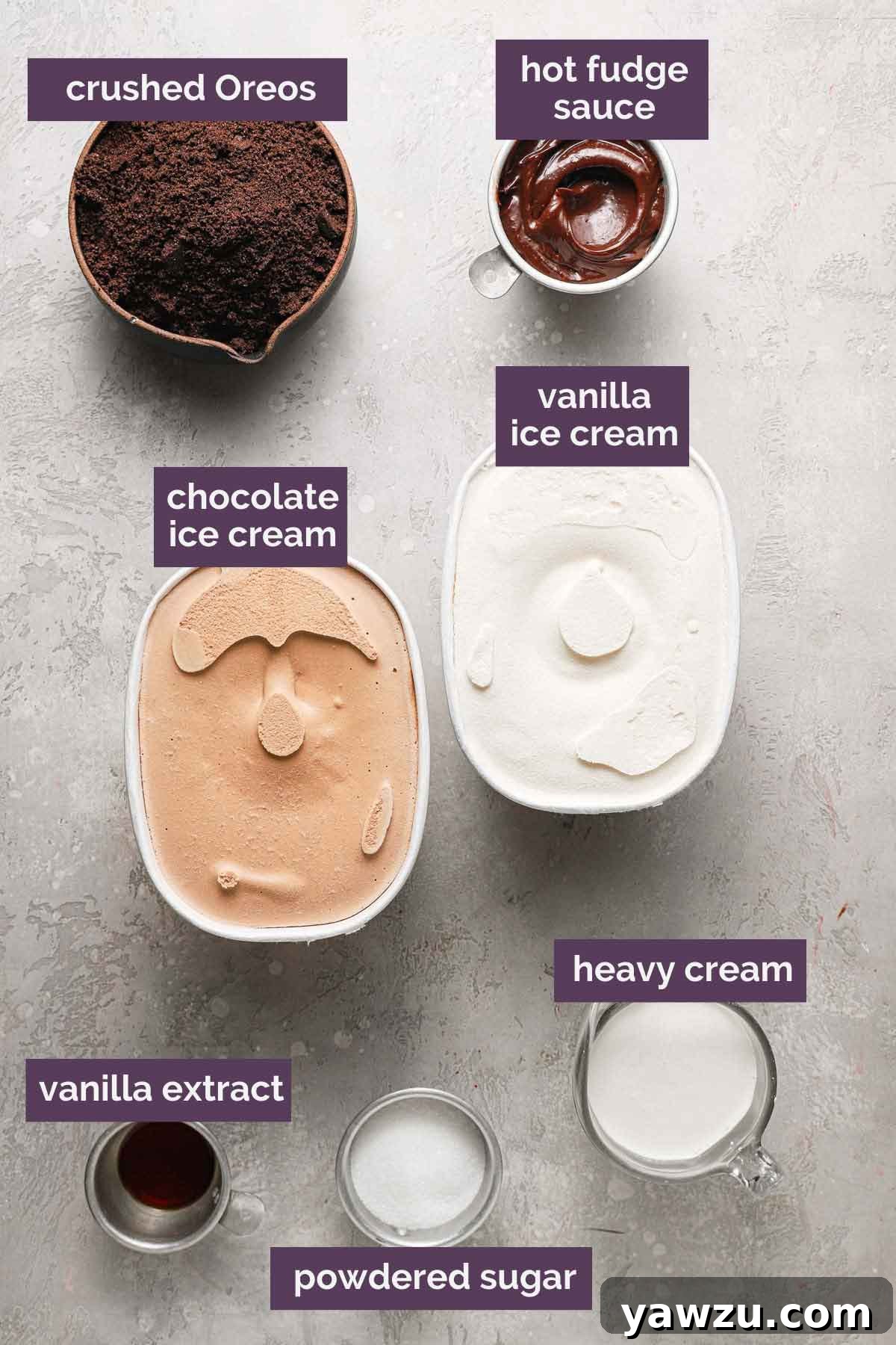 A selection of ingredients for making a homemade ice cream cake, including tubs of chocolate and vanilla ice cream, a jar of hot fudge, and a package of Oreo cookies, all neatly arranged.