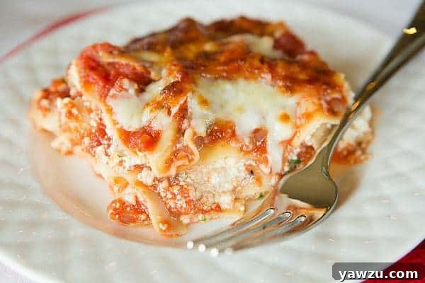 A tantalizing cross-section of homemade Classic Lasagna, highlighting the creamy ricotta and hearty meat sauce layers