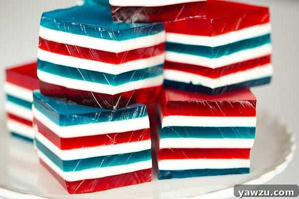 Close-up of a neatly cut Red, White & Blue Layered Finger Jello dessert, showcasing the distinct layers
