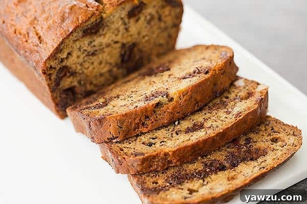 Close-up of a slice of Dark Chocolate Chunk & Walnut Banana Bread, showing its rich texture and inclusions