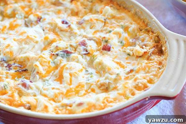 Warm and gooey bacon dip with potato chips on the side, perfect for sharing
