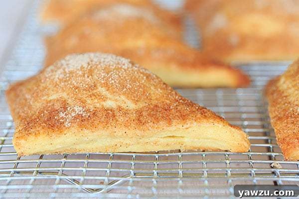 Stack of golden-brown apple turnovers, ready to be enjoyed.