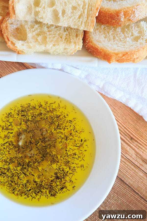 Rich Roasted Garlic & Herb Dipping Oil served with crusty Italian bread, an ideal light appetizer.