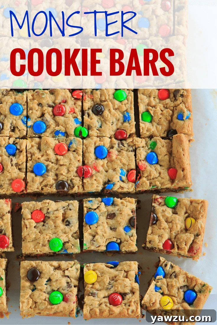 Monster Cookie Bars - Rich peanut butter dough packed with hearty oats, decadent chocolate chips, and colorful M&M's for a delightful treat.