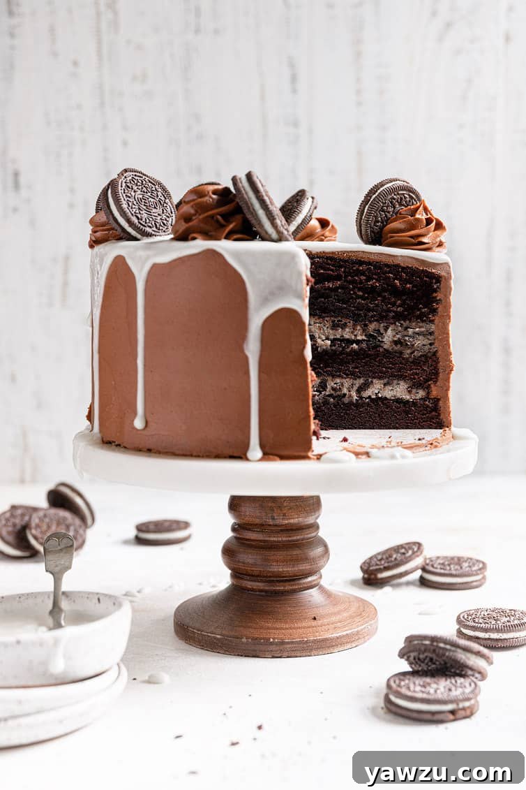 A meticulously sliced three-layer Oreo cake revealing its delicious interior, placed on a elegant cake stand.