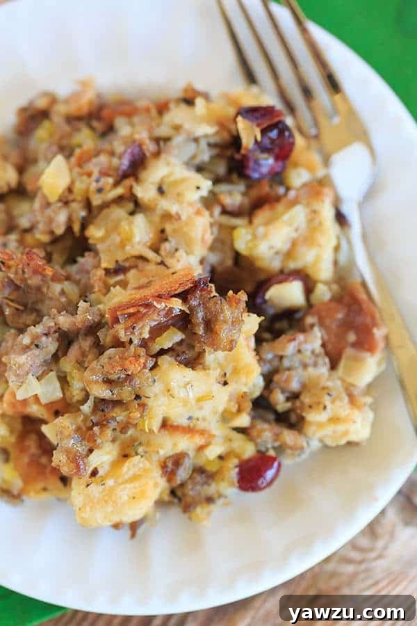 Sausage, Apple & Sage Stuffing made with Challah bread. A perfectly golden-brown, moist stuffing with crisp corners, ready for Thanksgiving. | https://www.browneyedbaker.com/sausage-apple-sage-stuffing/