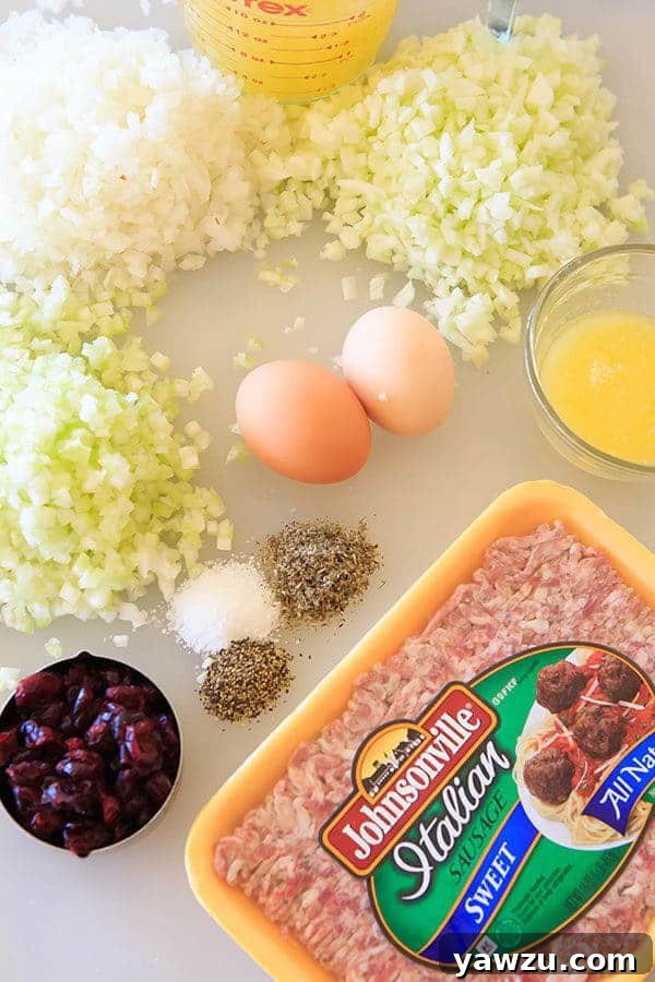 Close-up of Sausage, Apple & Sage Stuffing made with Challah bread, showing the texture and ingredients. | https://www.browneyedbaker.com/sausage-apple-sage-stuffing/