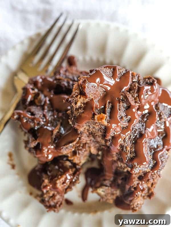 Rich and decadent chocolate bread pudding, a perfect dessert for any special occasion, topped with whipped cream and chocolate sauce.