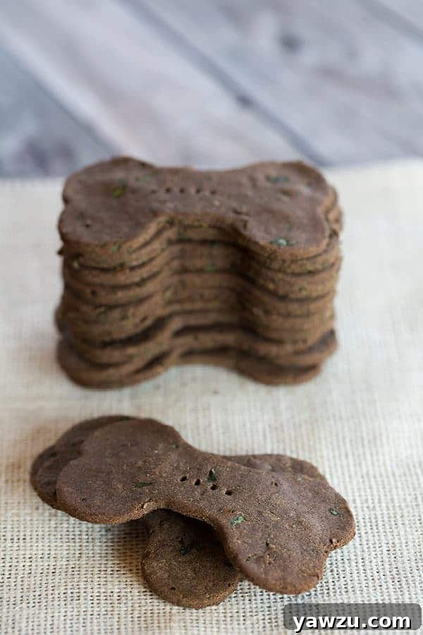 Close-up of baked mint and parsley buckwheat dog treats shaped like bones