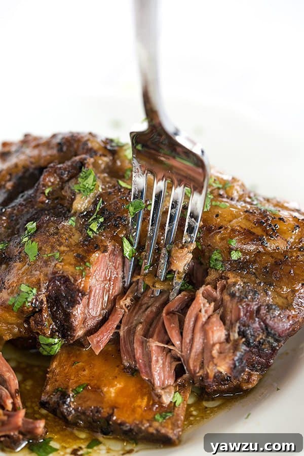 Slow Cooker Korean Short Ribs: An easy, 'set it and forget it' meal brimming with amazing Korean BBQ flavor and succulent, fall-apart tender beef. A perfect weeknight dinner solution.