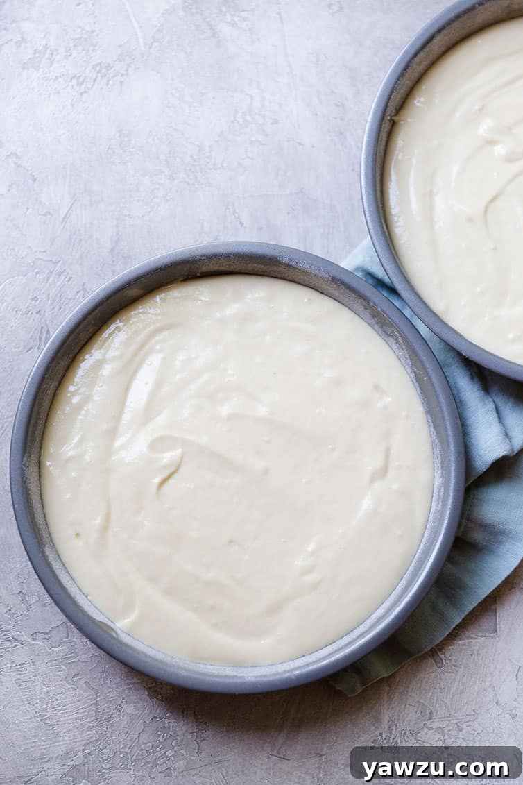 Prepared cake batter in pans.