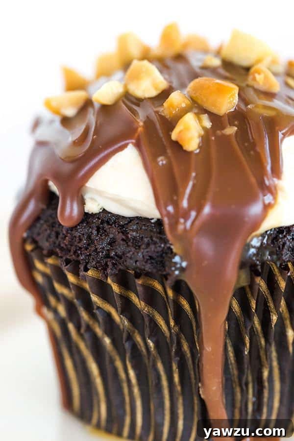 Close-up of a perfectly crafted Snickers cupcake, showcasing its layers of deliciousness.