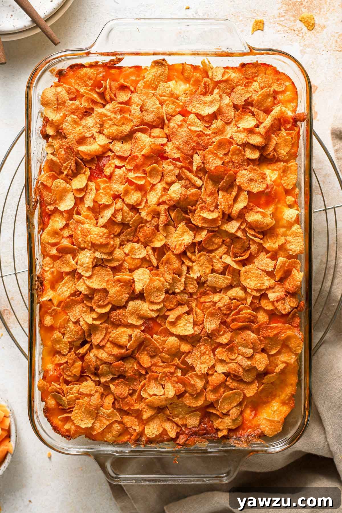 Overhead photo of baked cheesy potato casserole in a glass baking dish.
