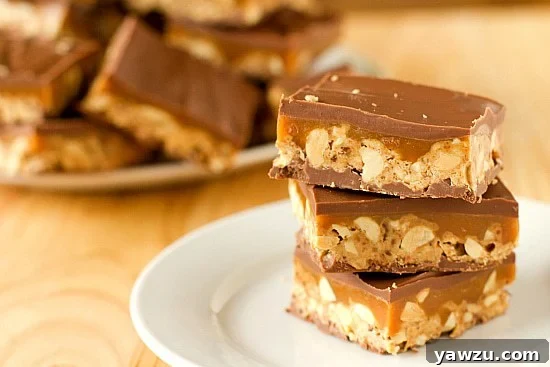 Homemade Snickers Bars: Layers of nougat, caramel, peanuts, and rich chocolate, creating a delightful homemade version of the classic candy bar.
