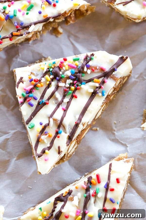 Crispy pretzels coated in rich toffee, topped with creamy white chocolate and colorful sprinkles, making a festive Pretzel Bark.