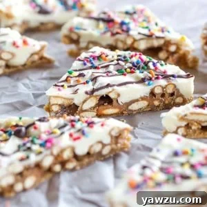 Pretzel Bark Candy close-up, featuring white chocolate, sprinkles, and a dark chocolate drizzle.