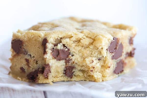 A stack of perfectly sliced chocolate chip cookie bars on a plate, ready to be enjoyed as a simple sweet snack.